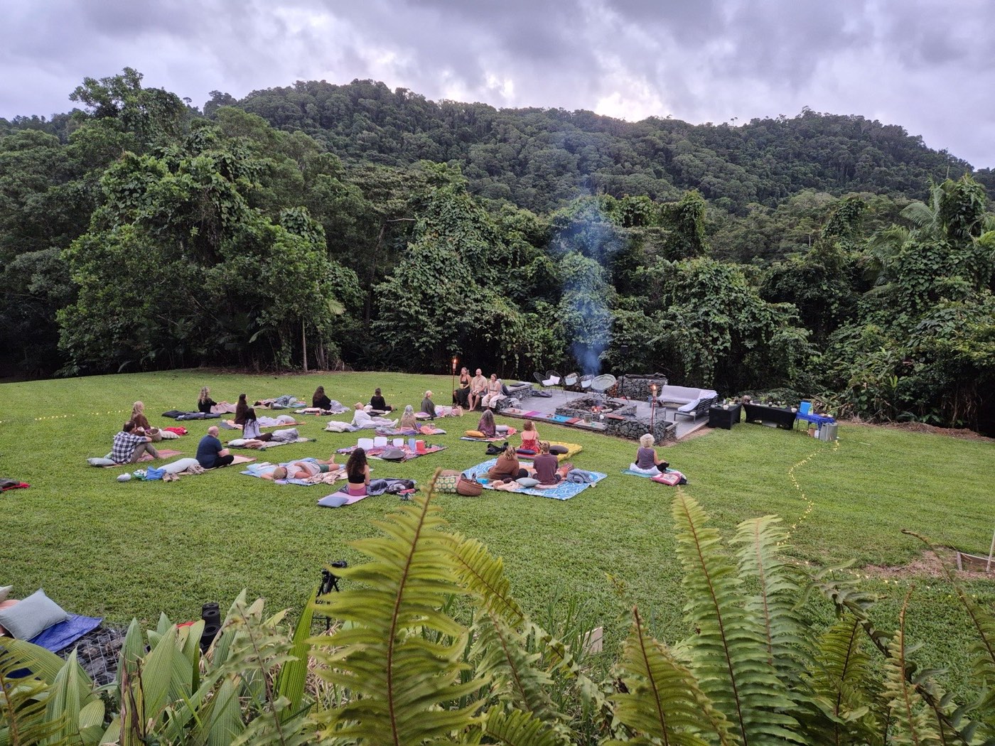 The circle takes shape on the lawn beneath a moody sky