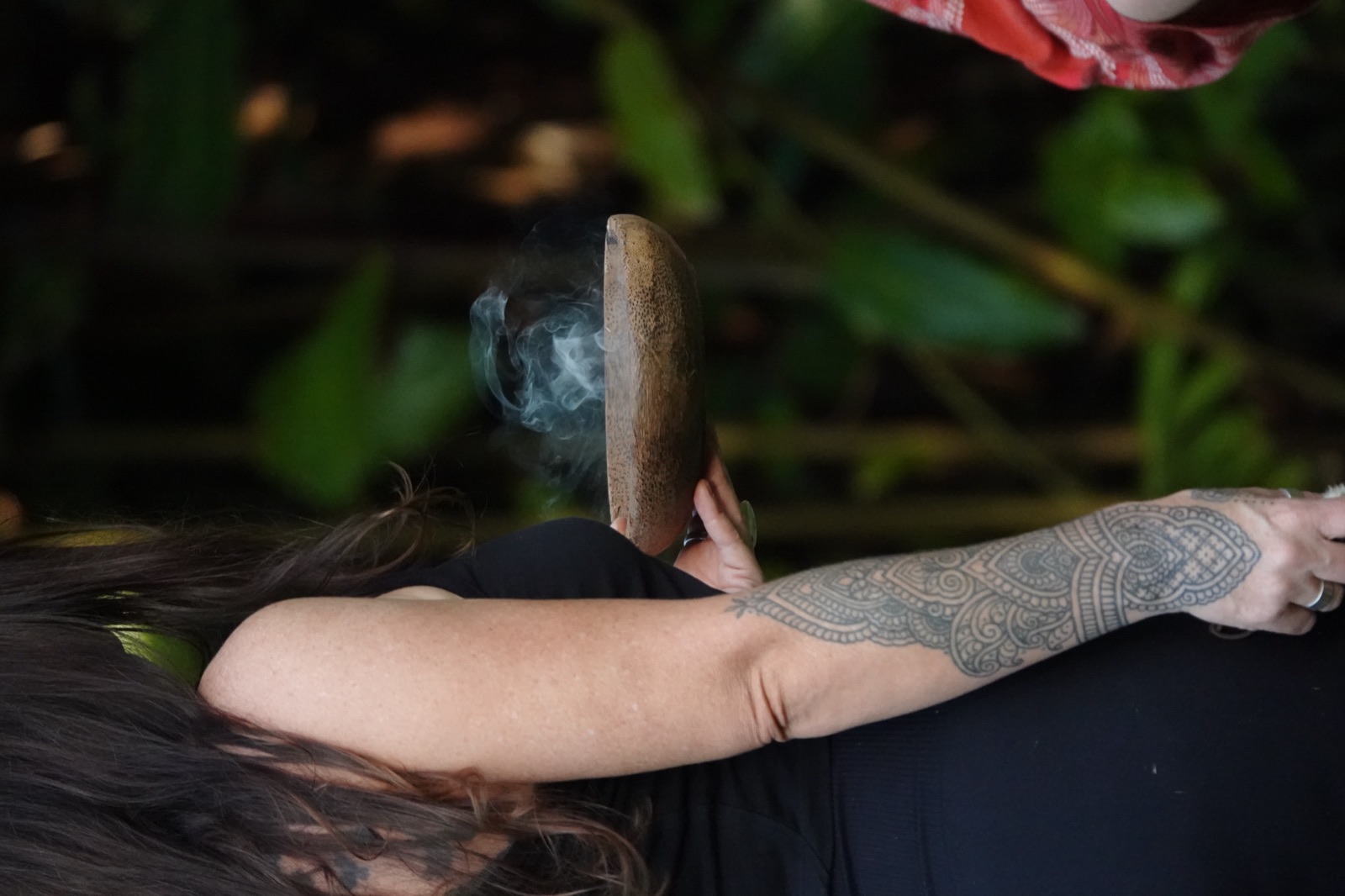 Sage smoke curling from the smudge bowl