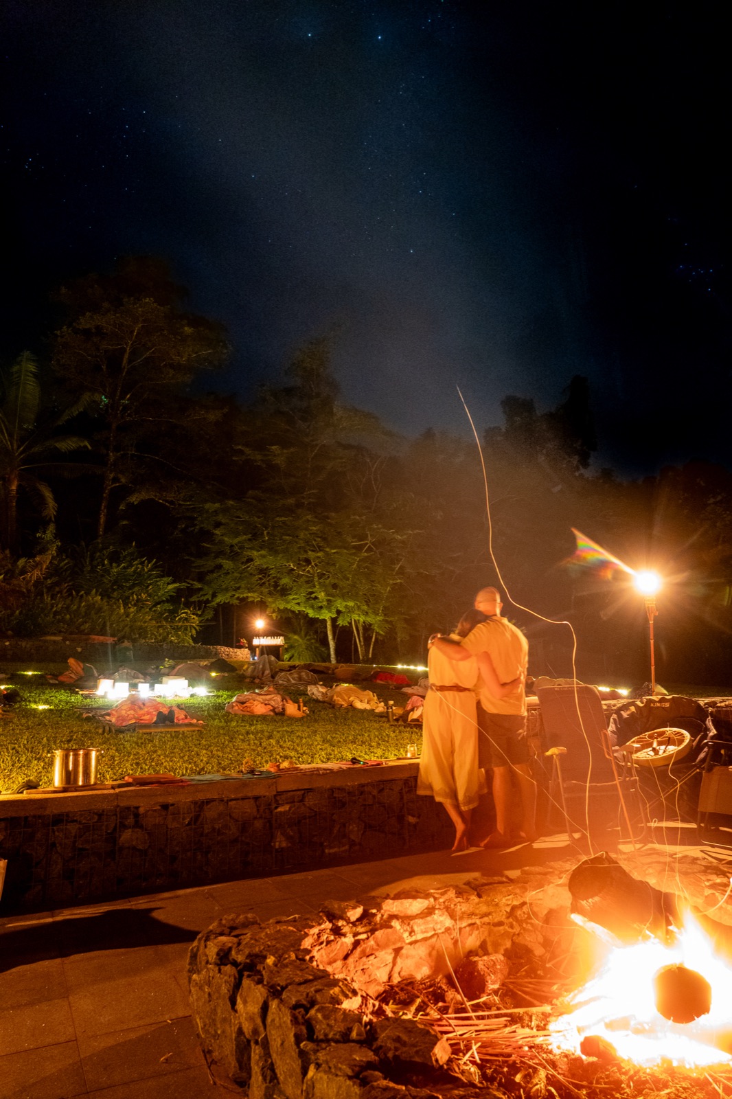 An embrace beside the fire pit as the stars come out