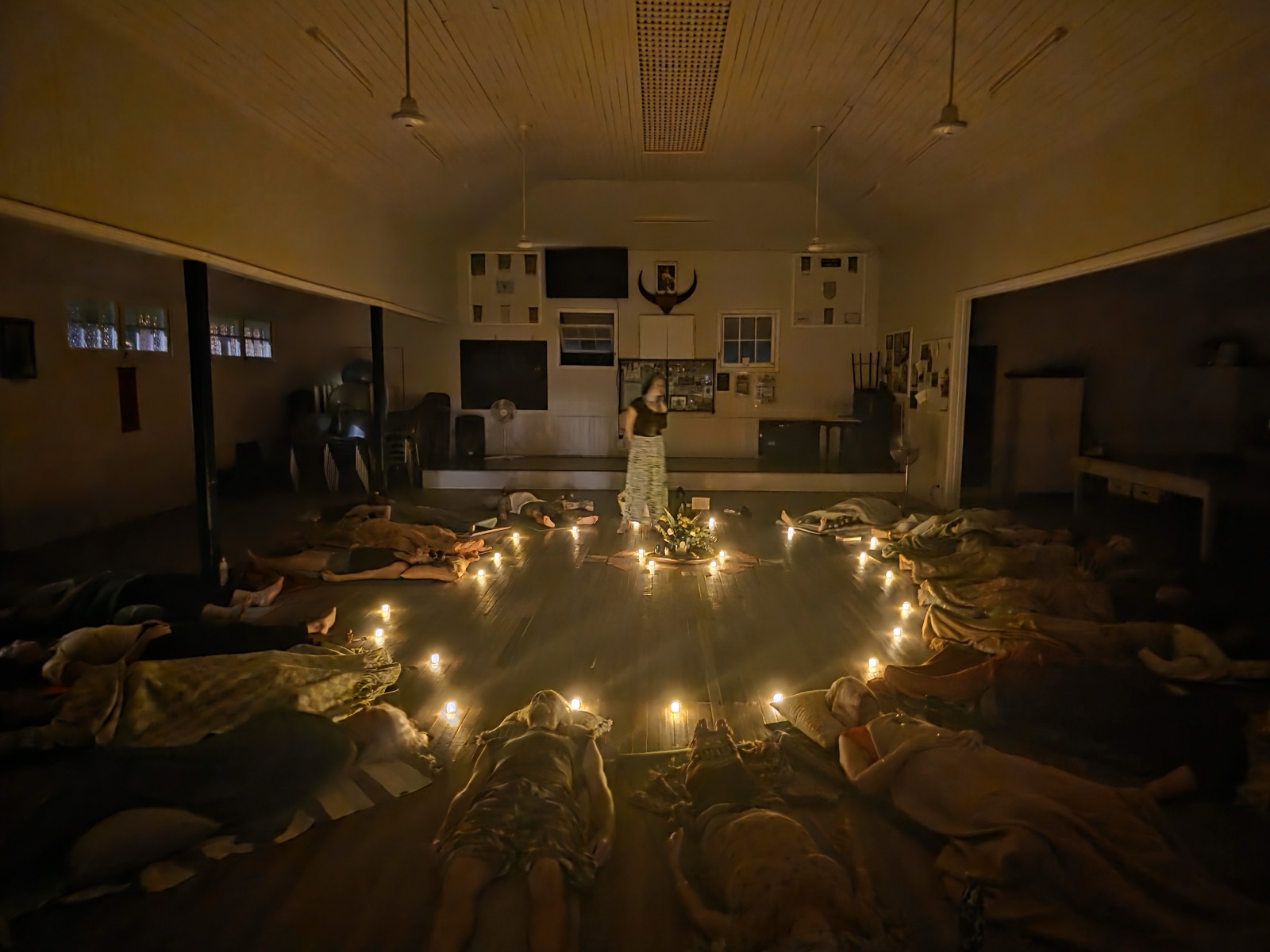 The candle-lit circle in full session at Buffs Hall